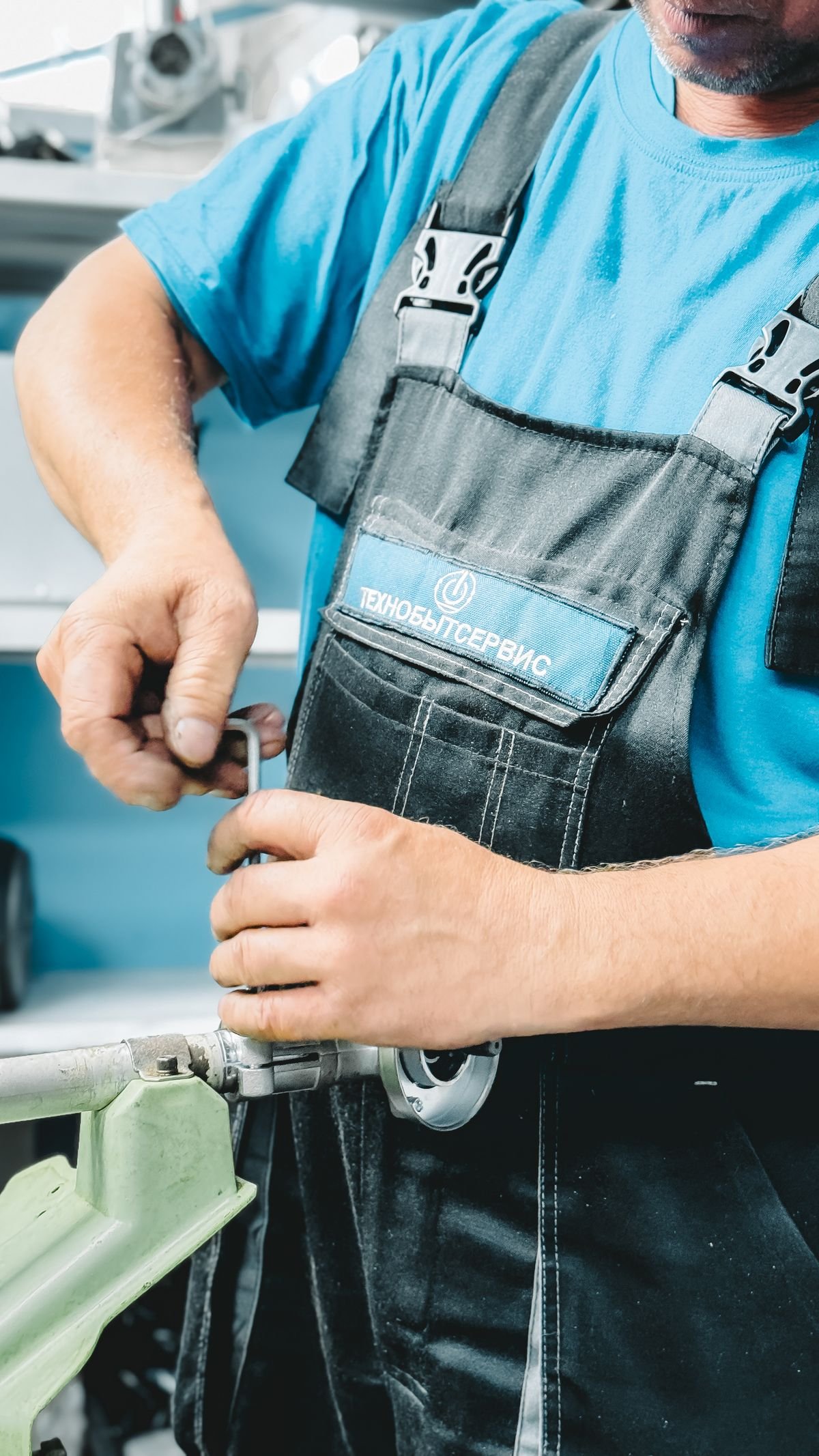 Plumber in work overalls holding a wrench, ready for a repair call